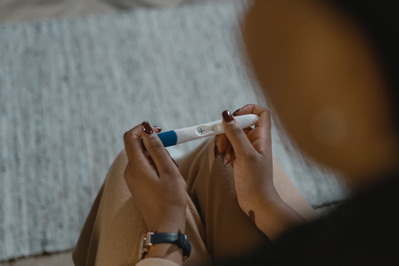 Crafting Captivating Headlines: Your awesome post title goes here Close-up of a woman holding a positive pregnancy test with a plus sign, symbolizing new beginnings.